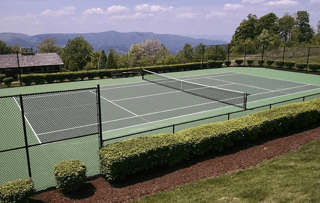 Resurfaced tennis court thanks to the affordable cost to install a tennis court. 