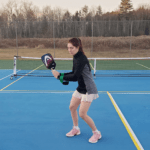woman using a pickleball training aid