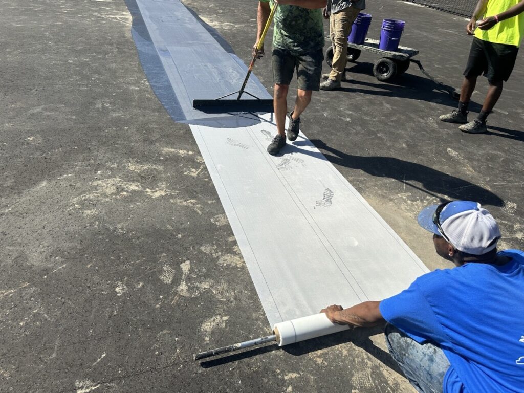 Poly pave court shield being applied to tennis court